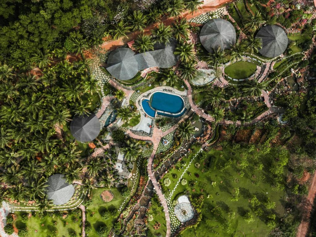una vista aérea de una piscina en un complejo en ama Stays & Trails Eden Farms Cottages, Goa, en Marmagao