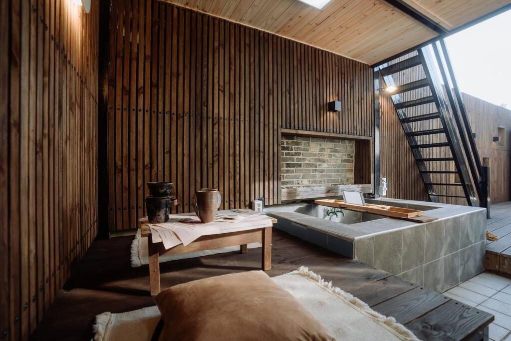 a large room with a bath tub and a table at Spring Night in Jeonju