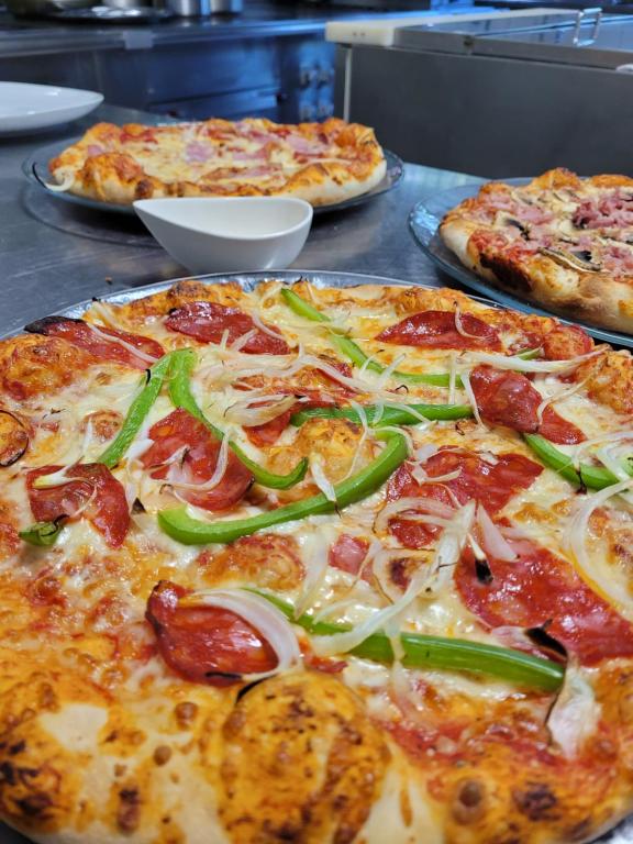 a group of pizzas sitting on top of a table at Auberge des Salles in Les Salles-sur-Verdon