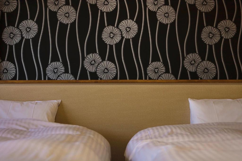 Postel nebo postele na pokoji v ubytování Japanese Onsen Ryokan Kohakuen
