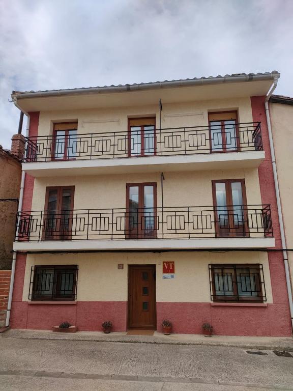 a red and white building with a balcony at CASA GLORIA in Ganuza