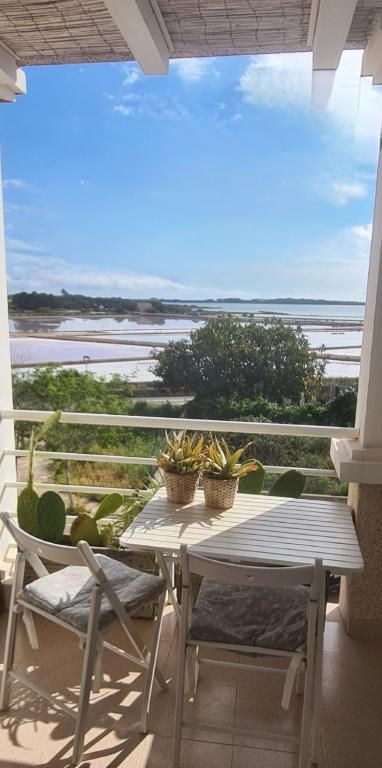 a table and chairs on a balcony with a view of the ocean at La Savina Ses Platgetes in La Savina