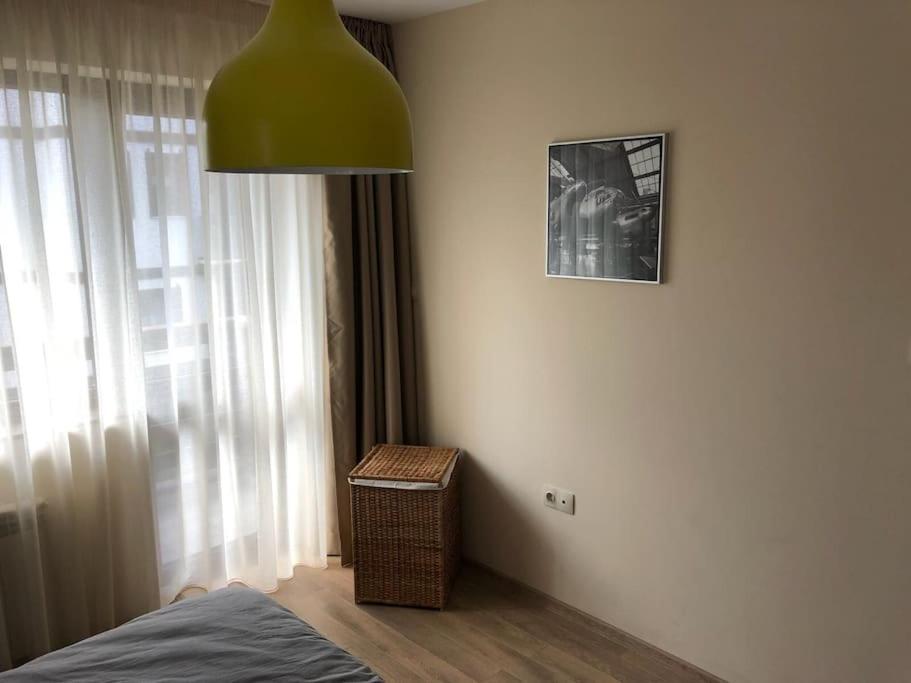 a bedroom with a bed and a green lamp at 2 BED APARTMENT IN BANSKO RESORT in Bansko