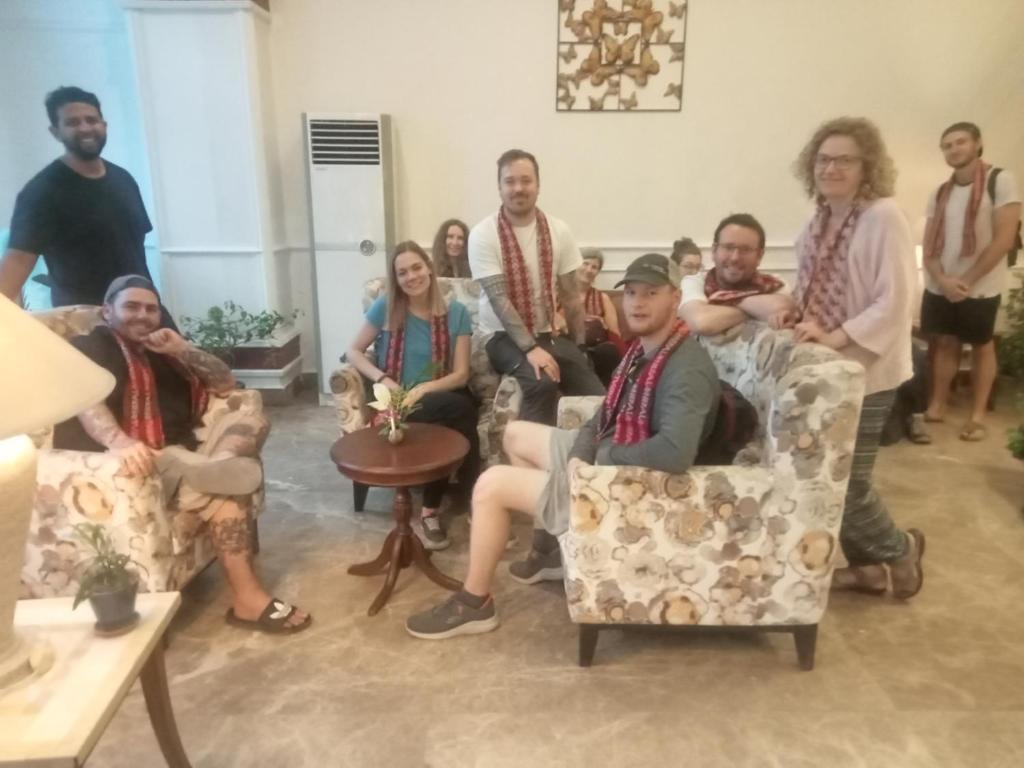 a group of people sitting in chairs in a room at Club De Novo Hotel in Butwāl
