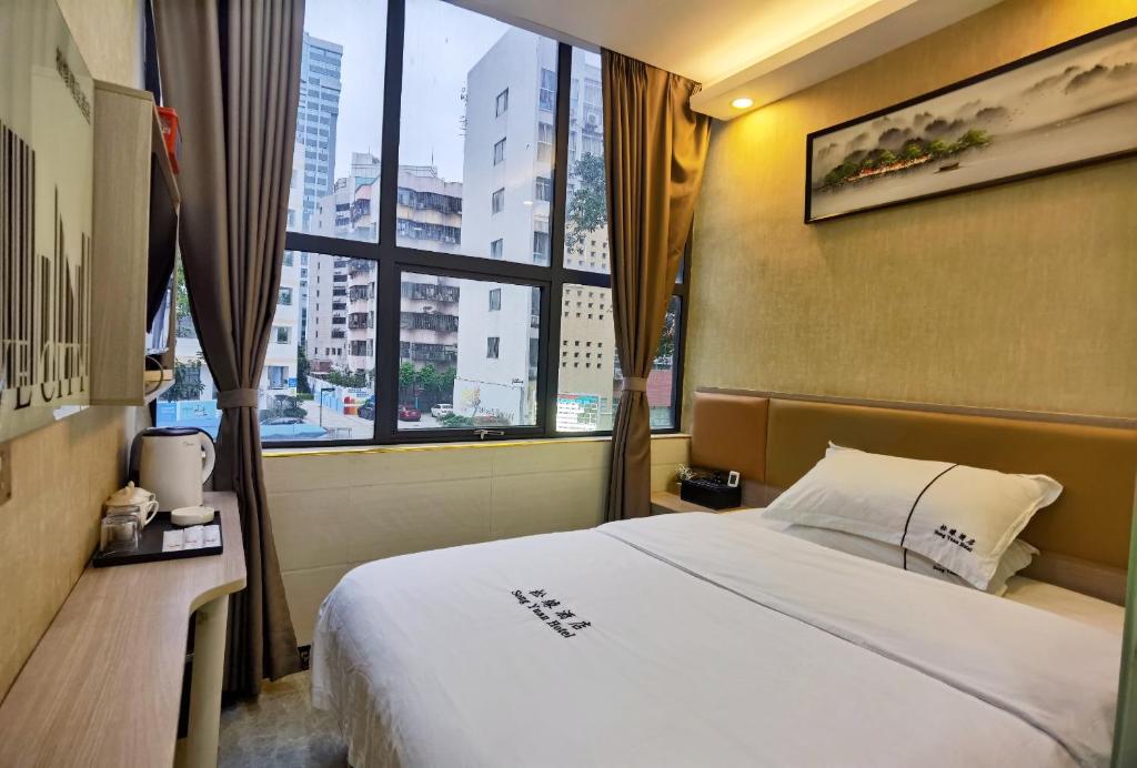 Postel nebo postele na pokoji v ubytování Songyuan Hotel 松缘酒店