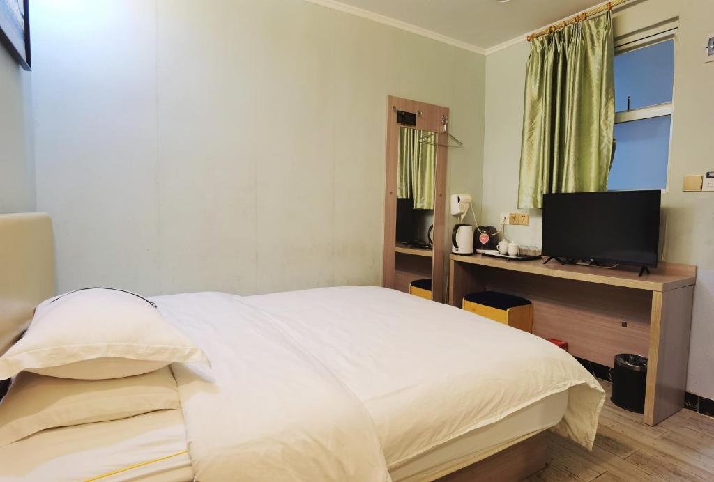 Postel nebo postele na pokoji v ubytování Songyuan Hotel 松缘酒店