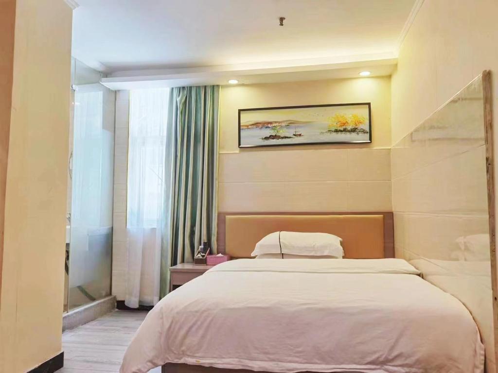 Postel nebo postele na pokoji v ubytování Songyuan Hotel 松缘酒店