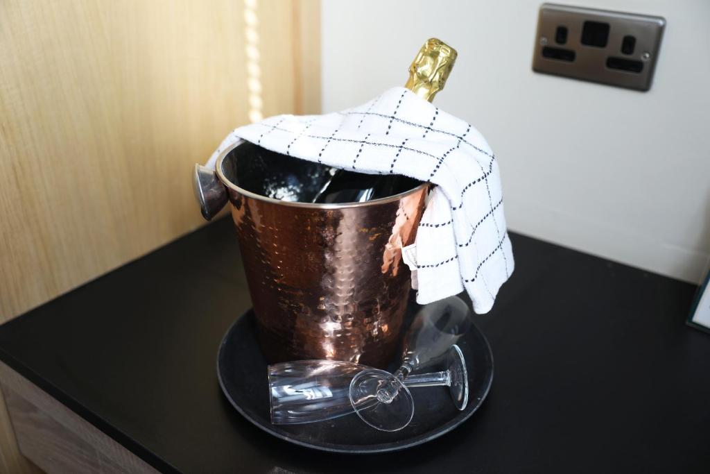 a bucket on a table with a towel on it at The Regent, Rye in Rye