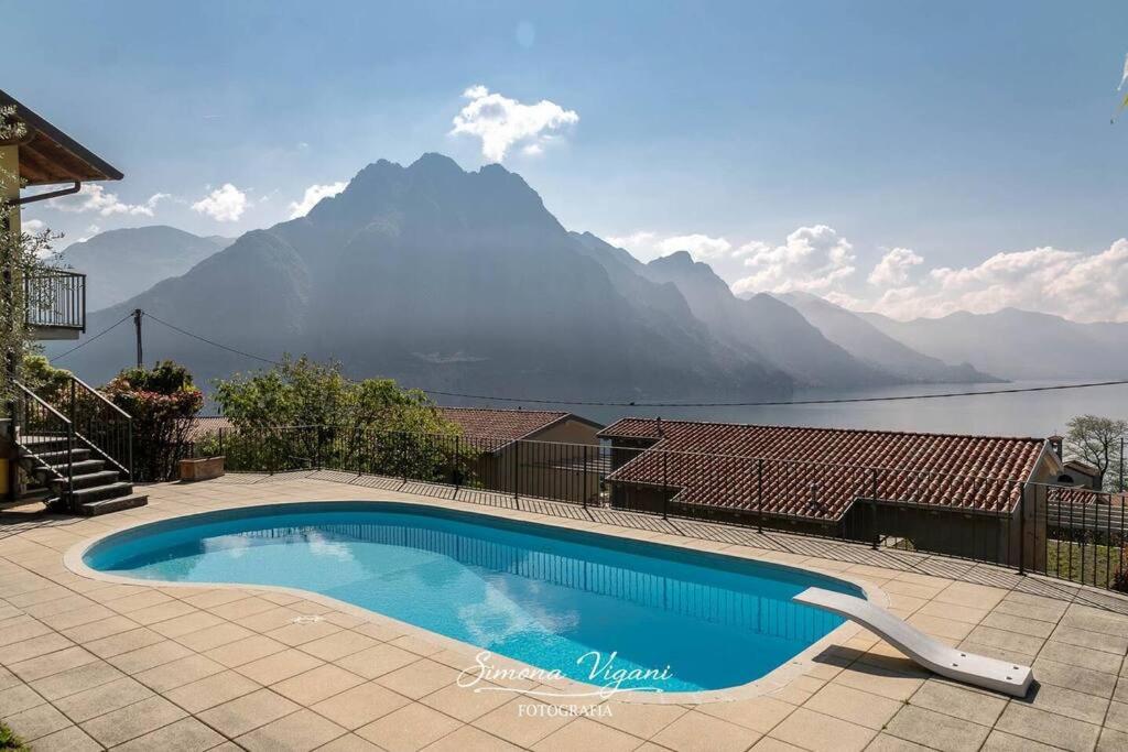 a swimming pool with a view of a mountain at Casa Acqua in Riva di Solto