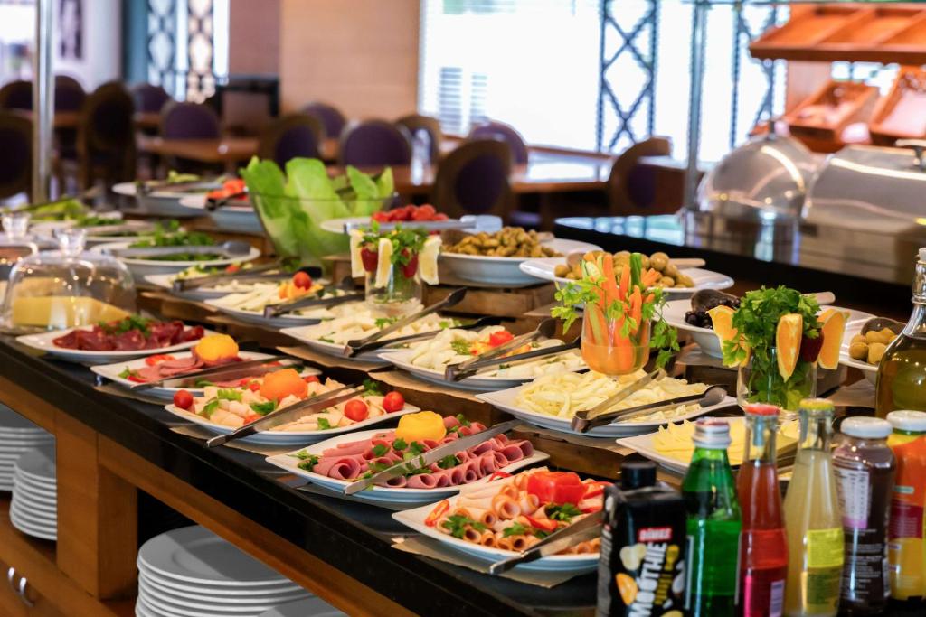 a buffet with many plates of food on a table at Park Inn by Radisson Istanbul Asia Kavacik in Istanbul