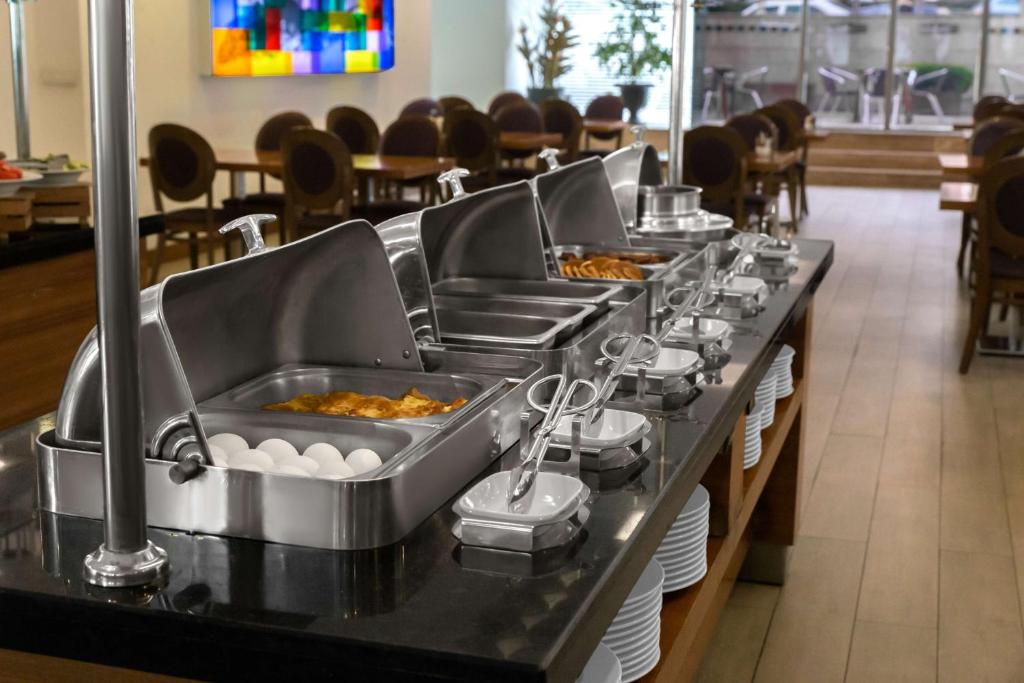 a buffet line with eggs in trays in a restaurant at Park Inn by Radisson Istanbul Asia Kavacik in Istanbul
