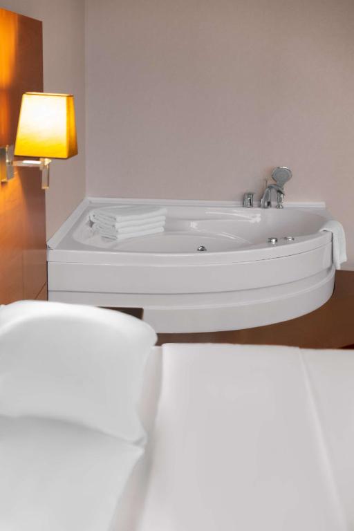 a bathroom with a white sink and a lamp at Park Inn by Radisson Istanbul Asia Kavacik in Istanbul