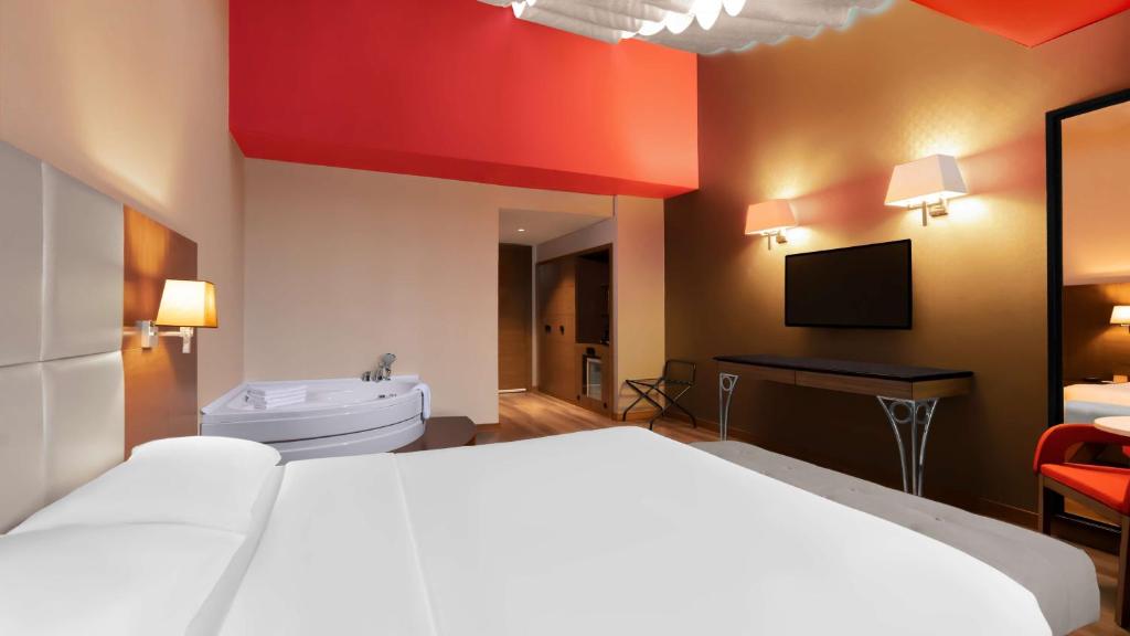 a hotel room with a bed and a tub and a television at Park Inn by Radisson Istanbul Asia Kavacik in Istanbul
