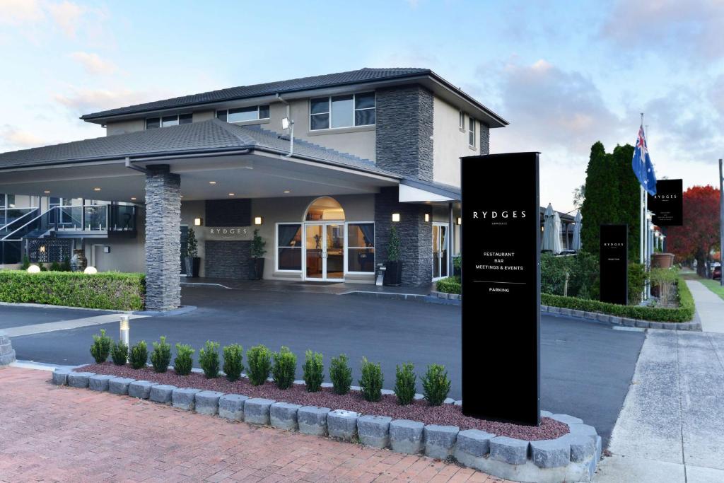 a building with a sign in front of it at Rydges Armidale in Armidale
