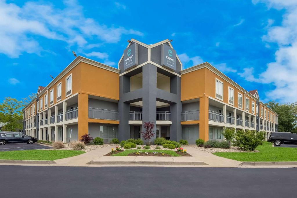 a building with a clock on the top of it at Clarion Pointe Indianapolis Northeast in Castleton