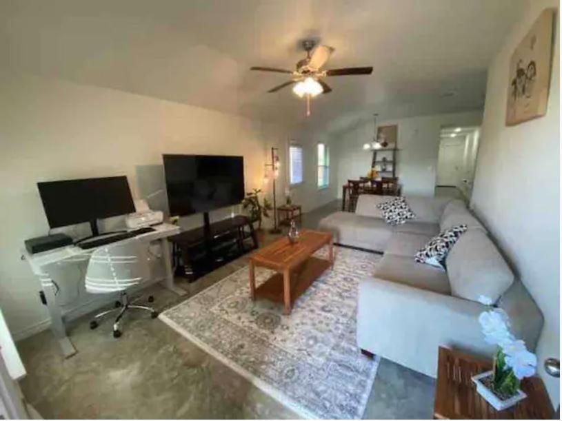 a living room with a couch and a tv at Fully Furnished with Full Kitchen Appliances, 3 Bedroom and 2 Bath Home in Killeen