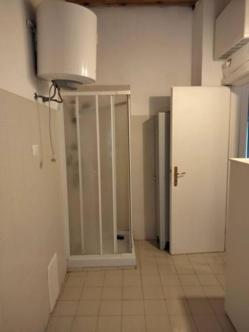 a kitchen with a white refrigerator and a light at Casa dell'Arco 31 in Camogli