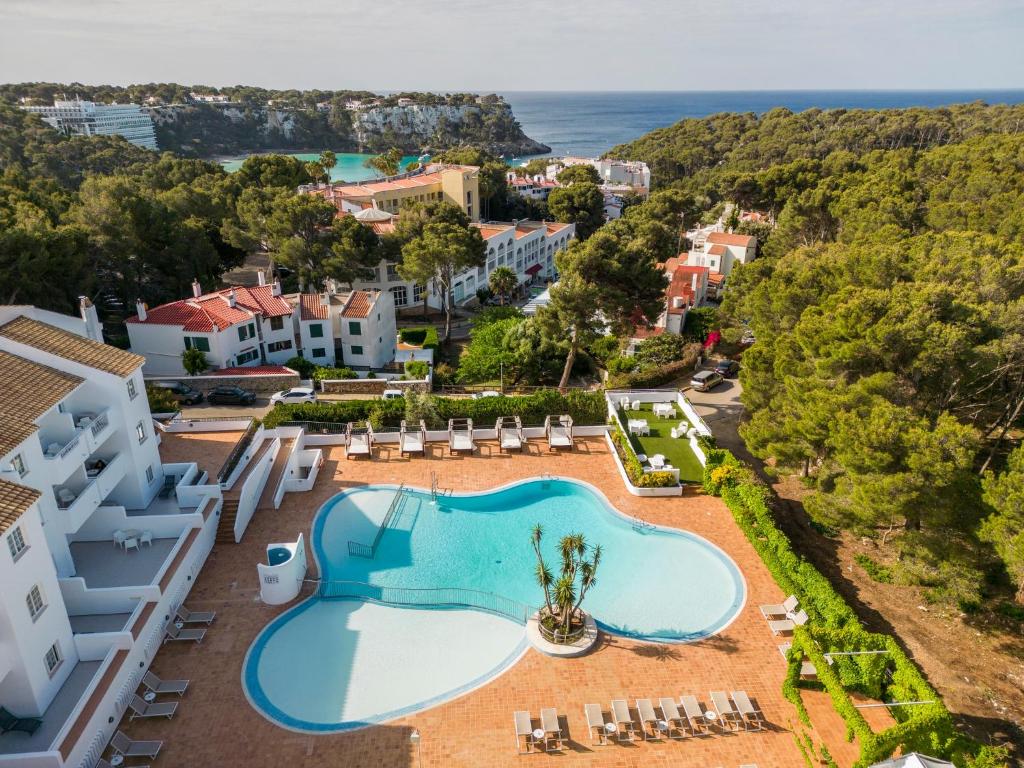 an aerial view of a resort with a swimming pool at Ilunion Menorca in Cala Galdana