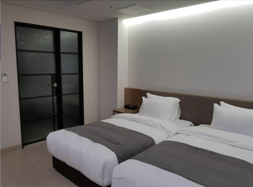 Postel nebo postele na pokoji v ubytování Hotel Ciel Dongtan