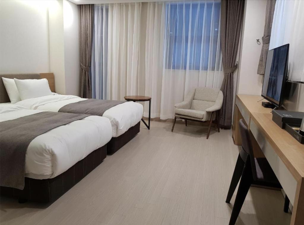 Postel nebo postele na pokoji v ubytování Hotel Ciel Dongtan
