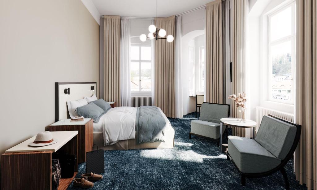 a bedroom with a bed and a chair at Esplanade Carlsbad in Karlovy Vary