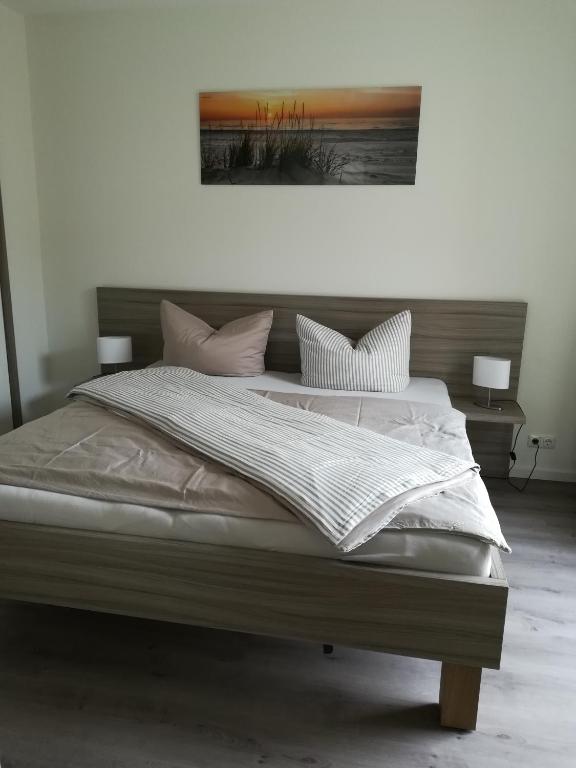 a bedroom with a large bed with white sheets and pillows at Apart Schleswig in Schleswig