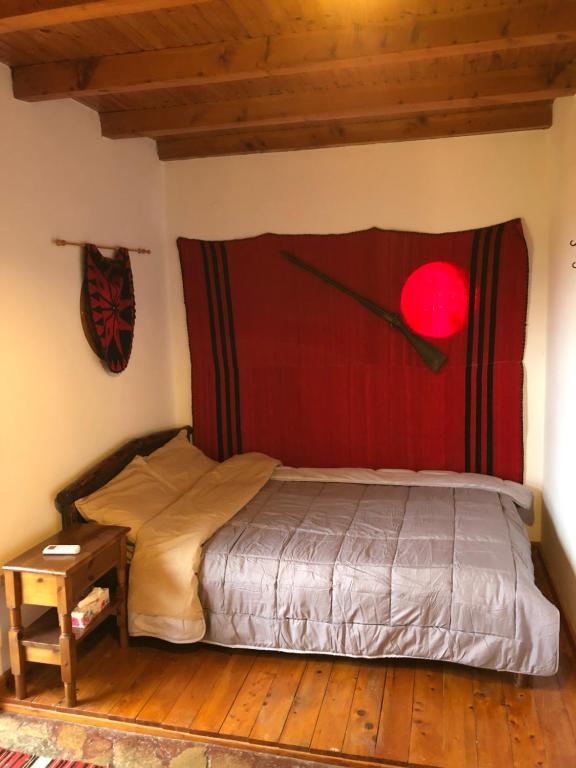 a bedroom with a bed with a red head board at Koumos in Kalyves