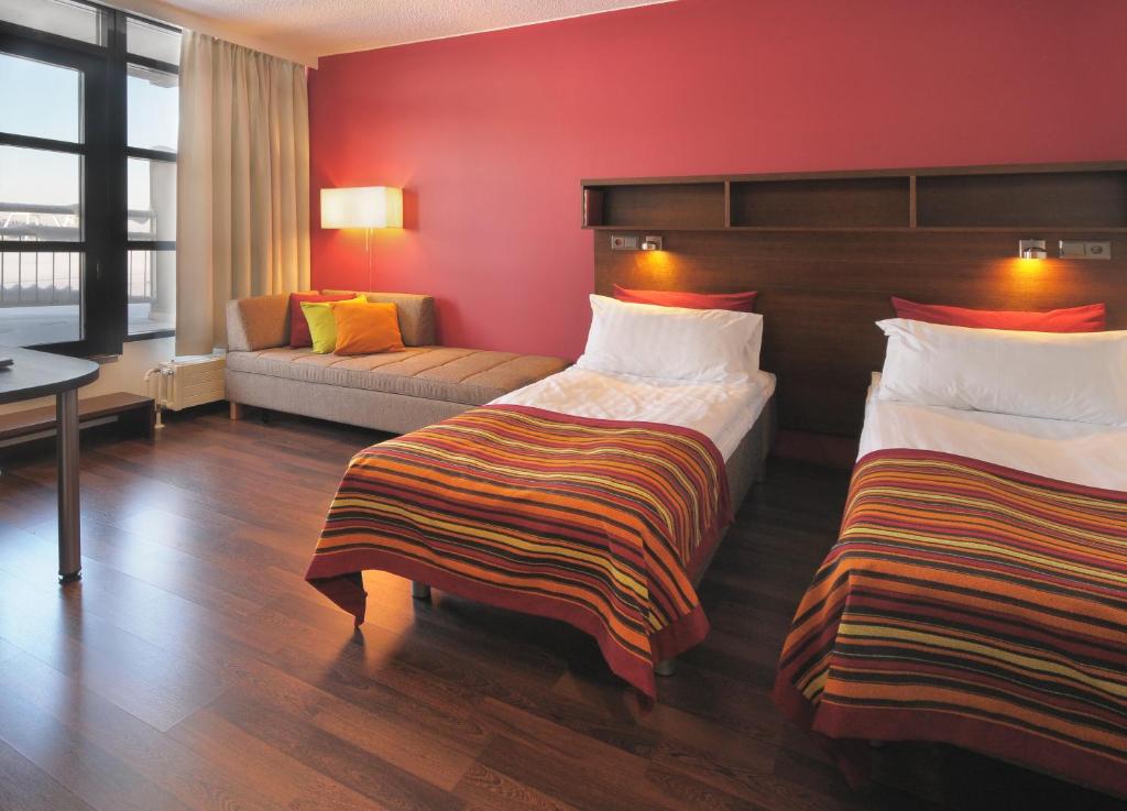 Postel nebo postele na pokoji v ubytování Sport & Spa Hotel Vesileppis