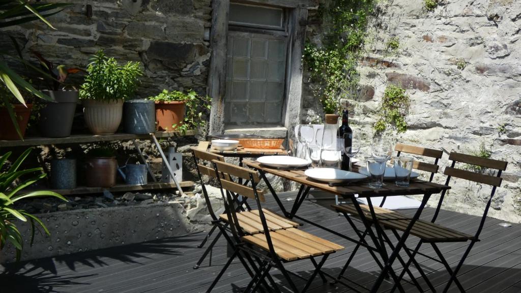 a wooden table and chairs on a patio at Maison Centre ville " 100 marches" in Morlaix