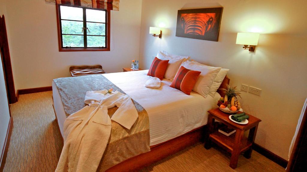 a bedroom with a large bed in a room at The Ark Lodge in Nyeri