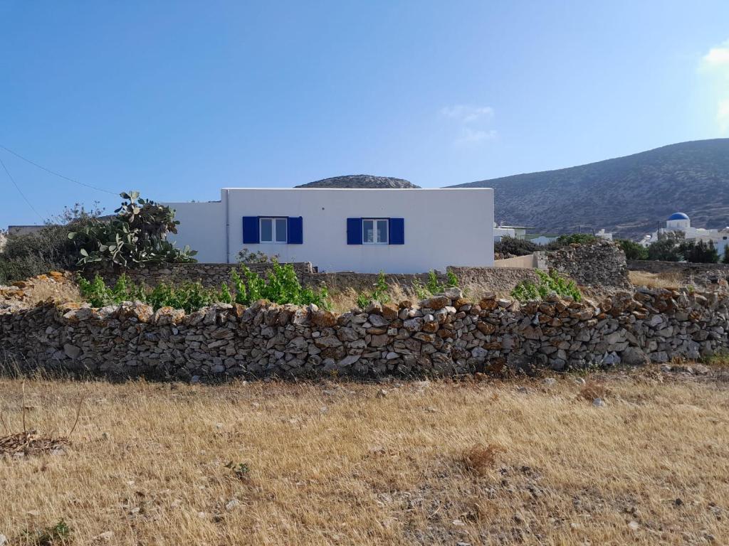 a house on a hill with a stone wall at Spíti Catharina in Irakleia