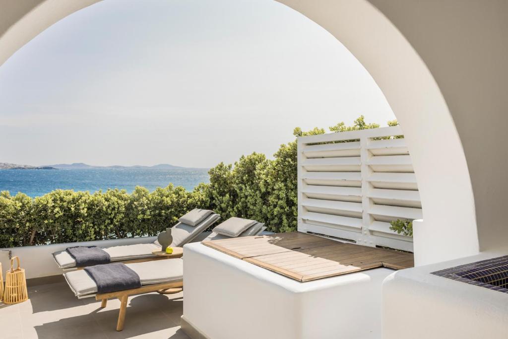 a patio with a view of the ocean at Grace Mykonos in Agios Stefanos