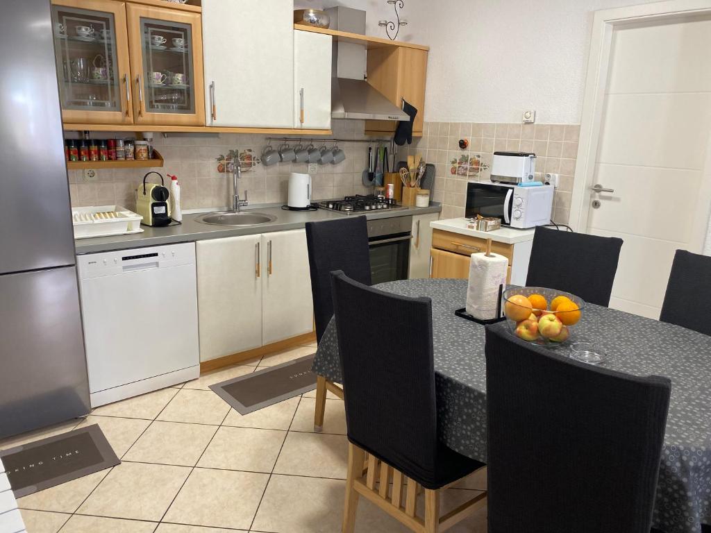 a kitchen with a table with fruit on it at House Bartulović in Brela