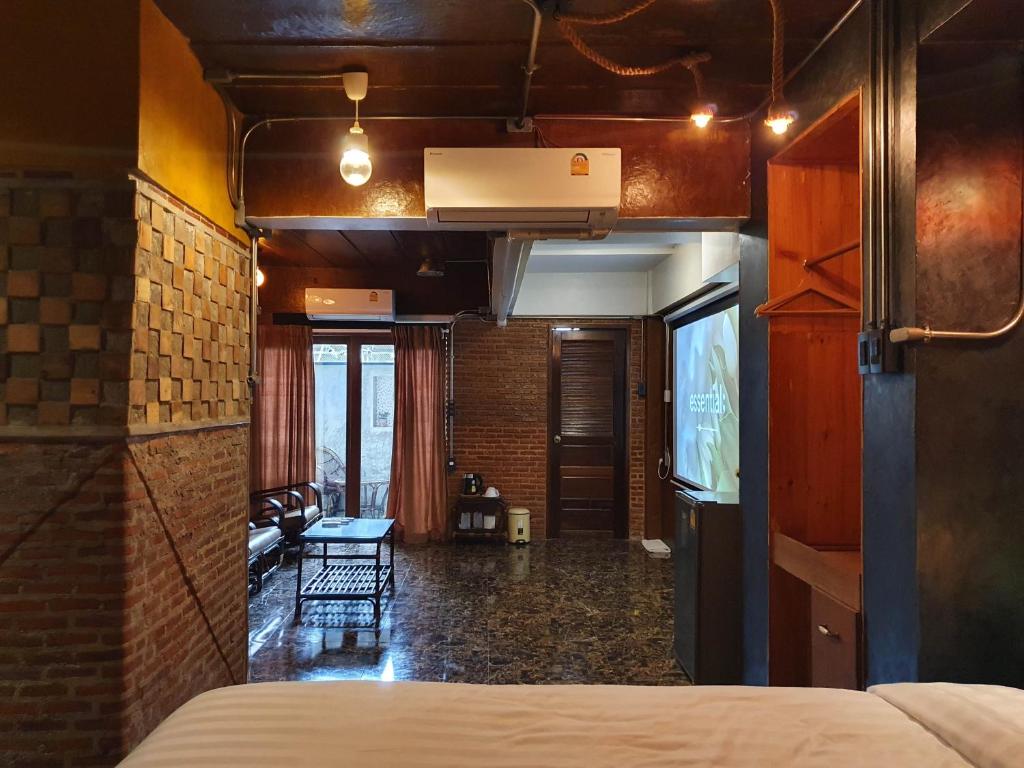 a bedroom with a bed and a living room at Vintage54 Hotel Ayutthaya in Phra Nakhon Si Ayutthaya