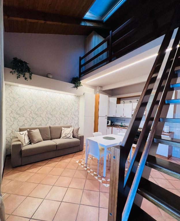 a living room with a couch and a table at V HOME in Biella