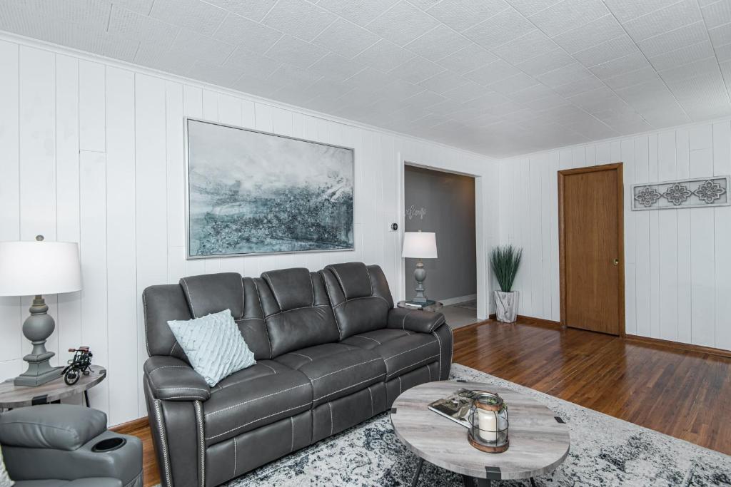 a living room with a couch and a table at 3 bedroom showstopper near Mayo Clinic in Rochester