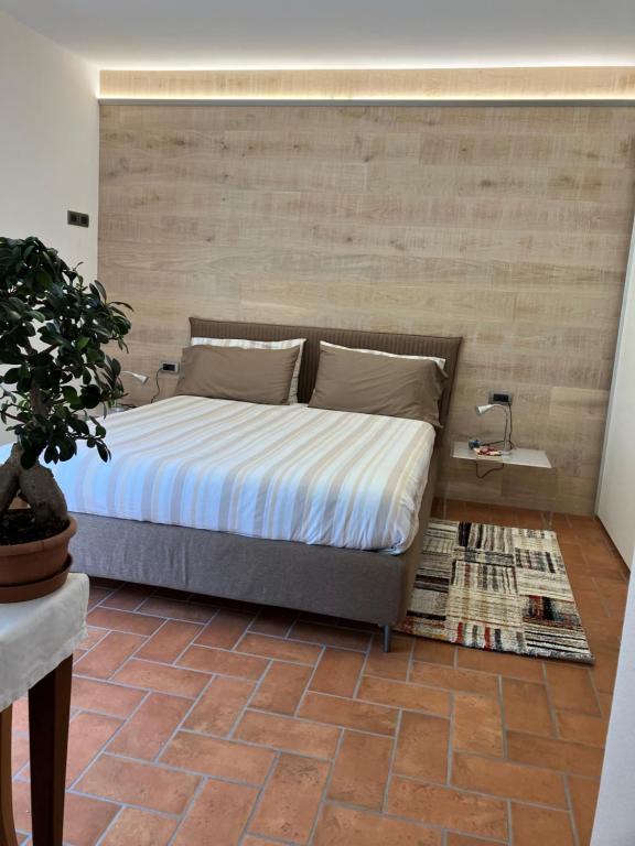 a bedroom with a bed with a brick floor at relaxing green panorama in Margno