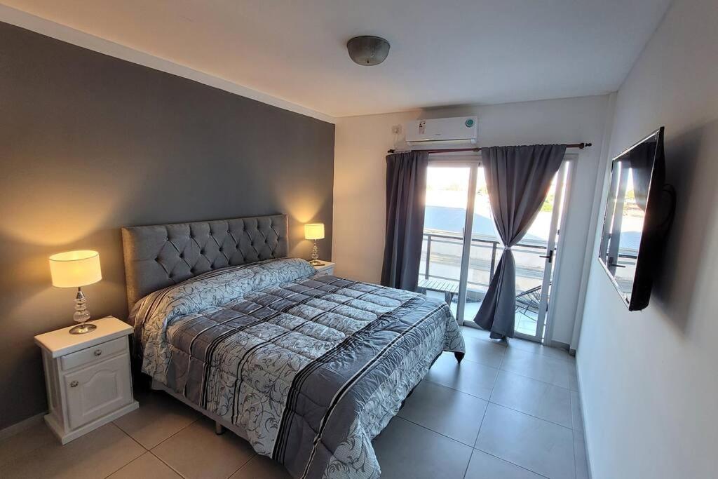 a bedroom with a bed and a view of the ocean at Departamento de Categoria Torre Costanera Norte, Corrientes in Corrientes