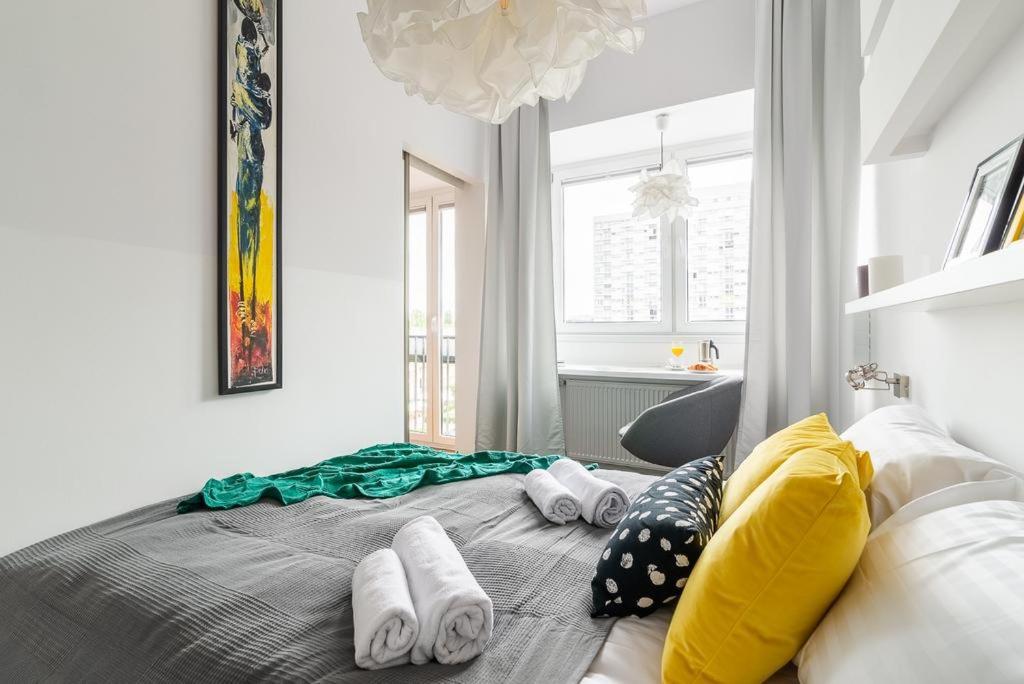 a bedroom with a bed with towels on it at Chłodna 15 by Homeprime in Warsaw