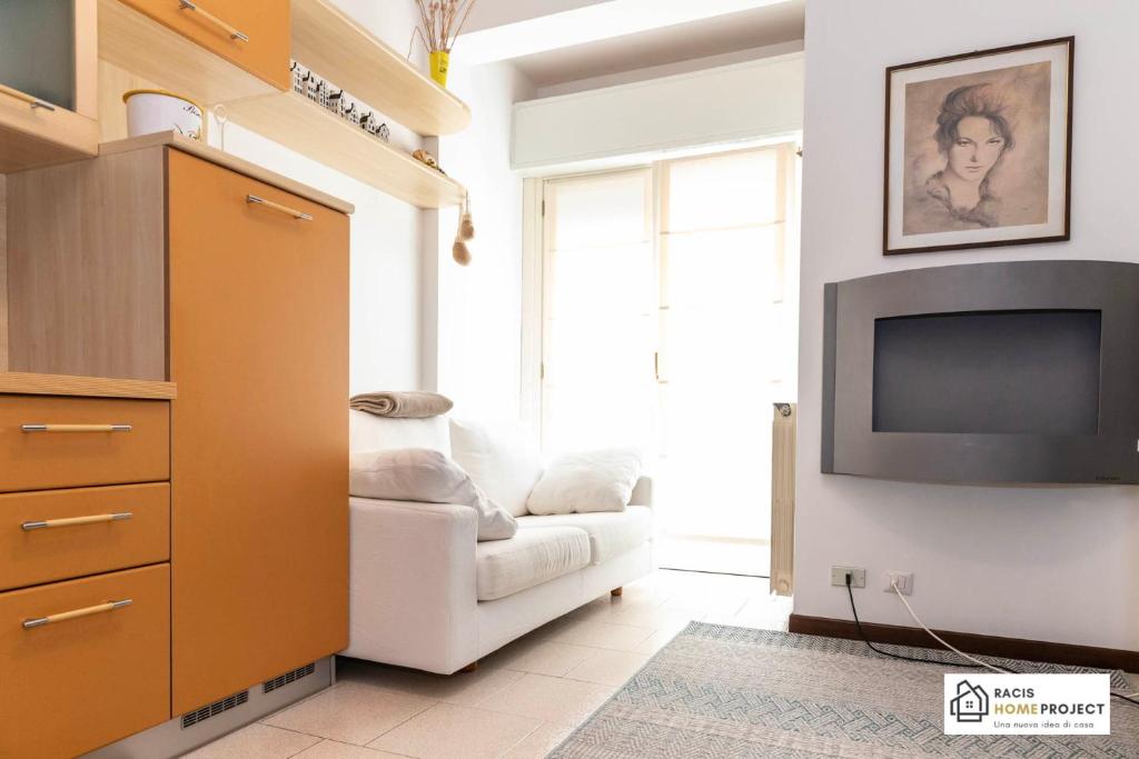 a living room with a couch and a tv at Casa Liviya - Appartamento con vista lago in Madonna del Sasso