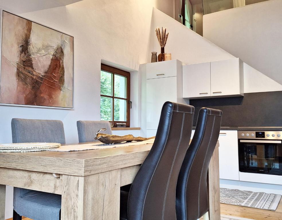 a kitchen with a wooden table and chairs at Haus Christine in Mieders