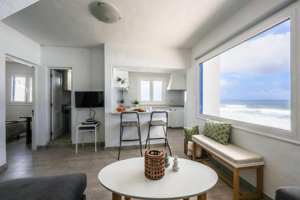 ein Wohnzimmer mit Blick auf das Meer in der Unterkunft Sweet La Ola in La Santa