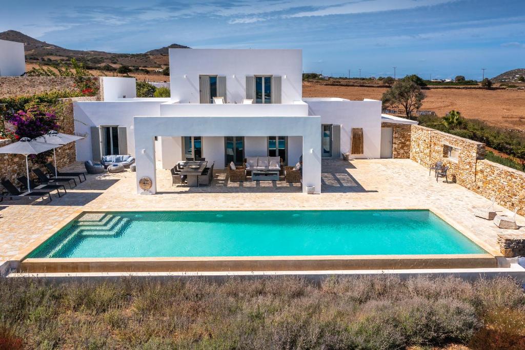 an external view of a villa with a swimming pool at The Gallery Home in Antiparos