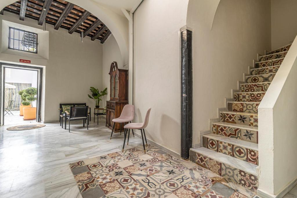 a living room with a staircase in a house at Casa Palacio Rufina & Jardines in Jerez de la Frontera