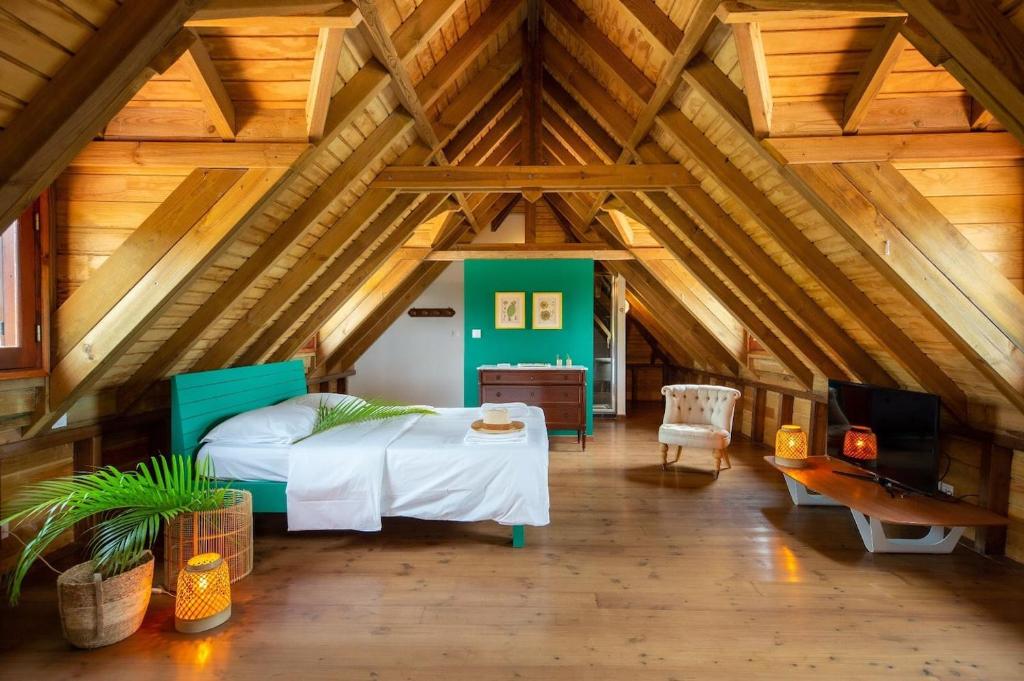 a bedroom with a bed in a room with wooden ceilings at Villa La Coulée d'Or in Le Vauclin