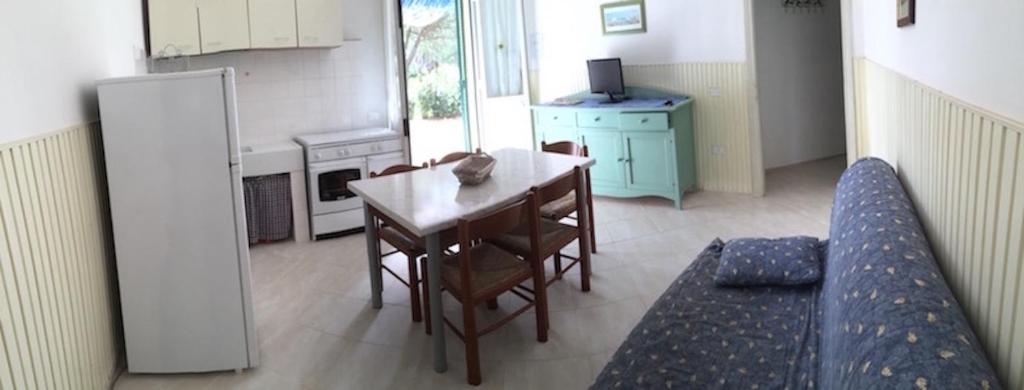 a kitchen with a table and chairs and a couch at Casa vacanze Rinsacca in Piombino