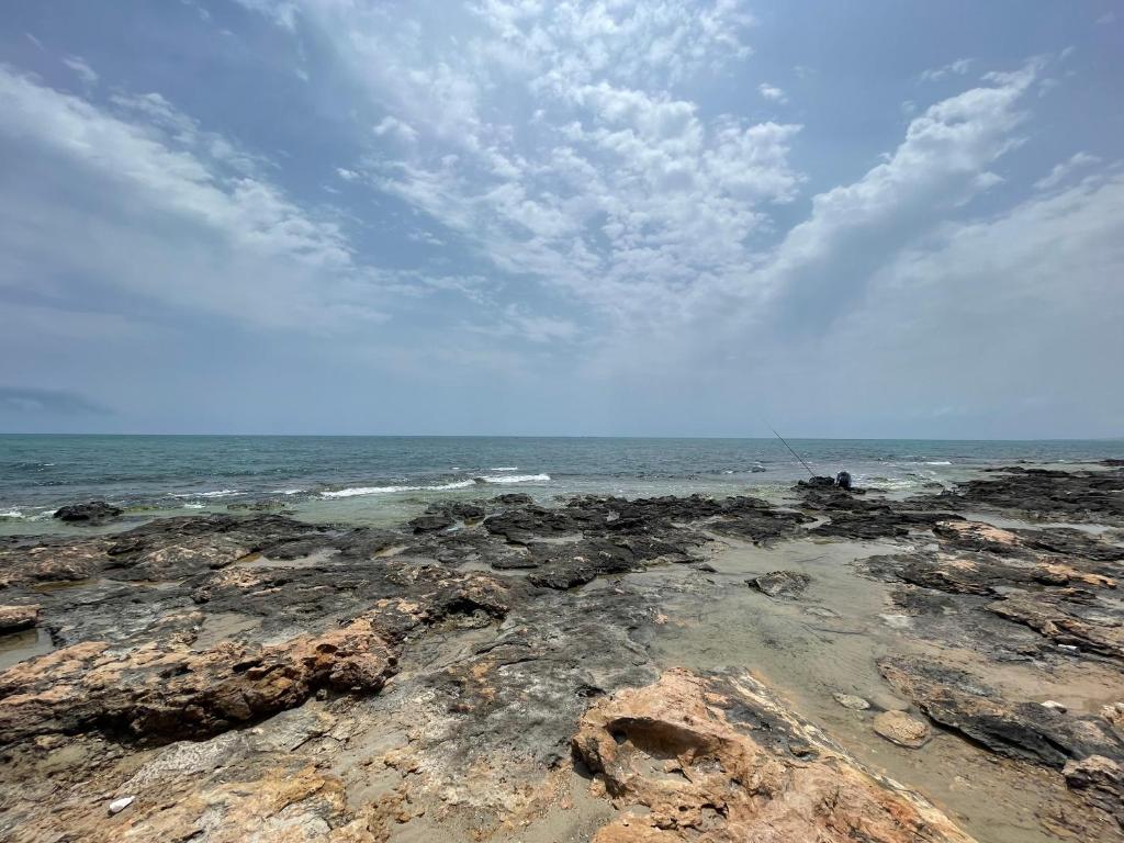 Beni KhiarにあるMaison cosy à deux pas de la merの曇りの日の岩と海の浜