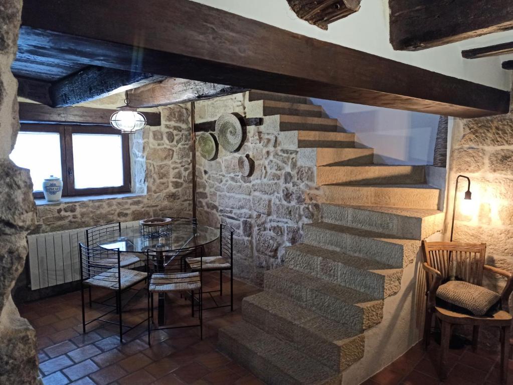 a staircase in a room with a table and chairs at Casa El Inglés in Mora de Rubielos