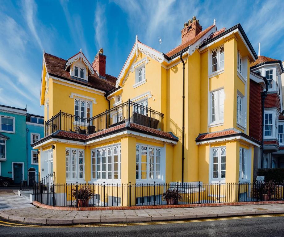 a yellow house on the side of a street at Ocean House, Tenby in Tenby