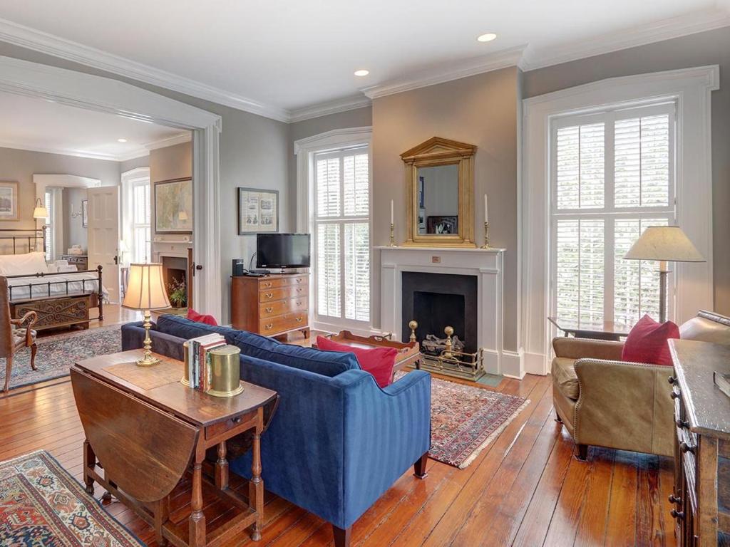 a living room with blue furniture and a fireplace at Bird Baldwin Twelve Oaks in Savannah